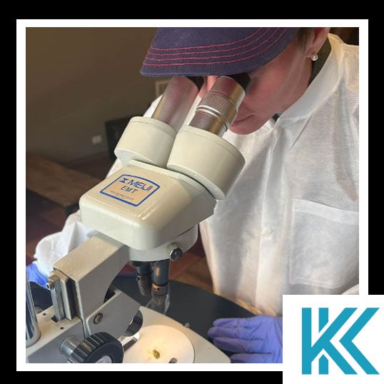 Keeley looking through a microscope